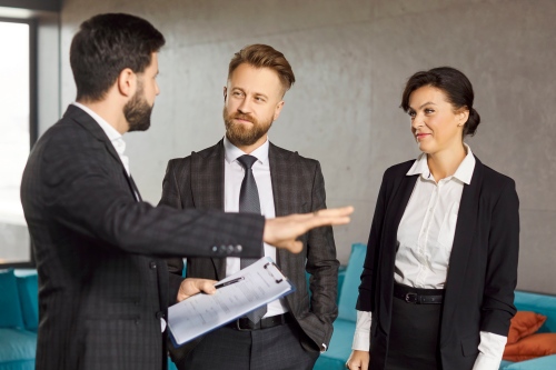 Property Manager discussing a deal with a set of potential residents in an office