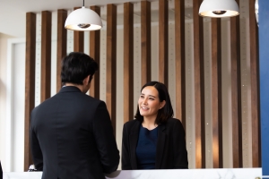 Friendly Concierge Talking to Resident at Her Desk